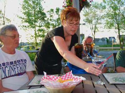 Caroline refreshes the drinks